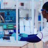 African woman biochemist researcher checking manifestations of vaccine working in modern equipped laboratory. Multiethnic doctors examining virus evolution using high tech researching diagnosis